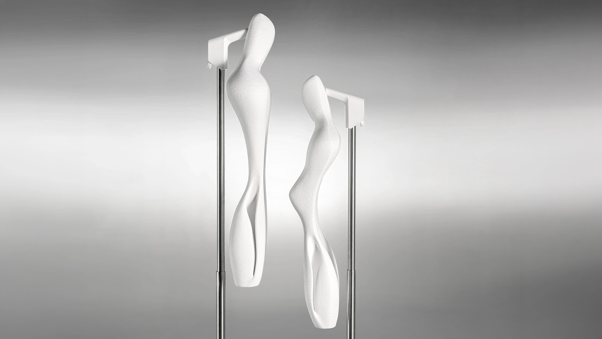 Female and male AERA white bust forms in front of each other