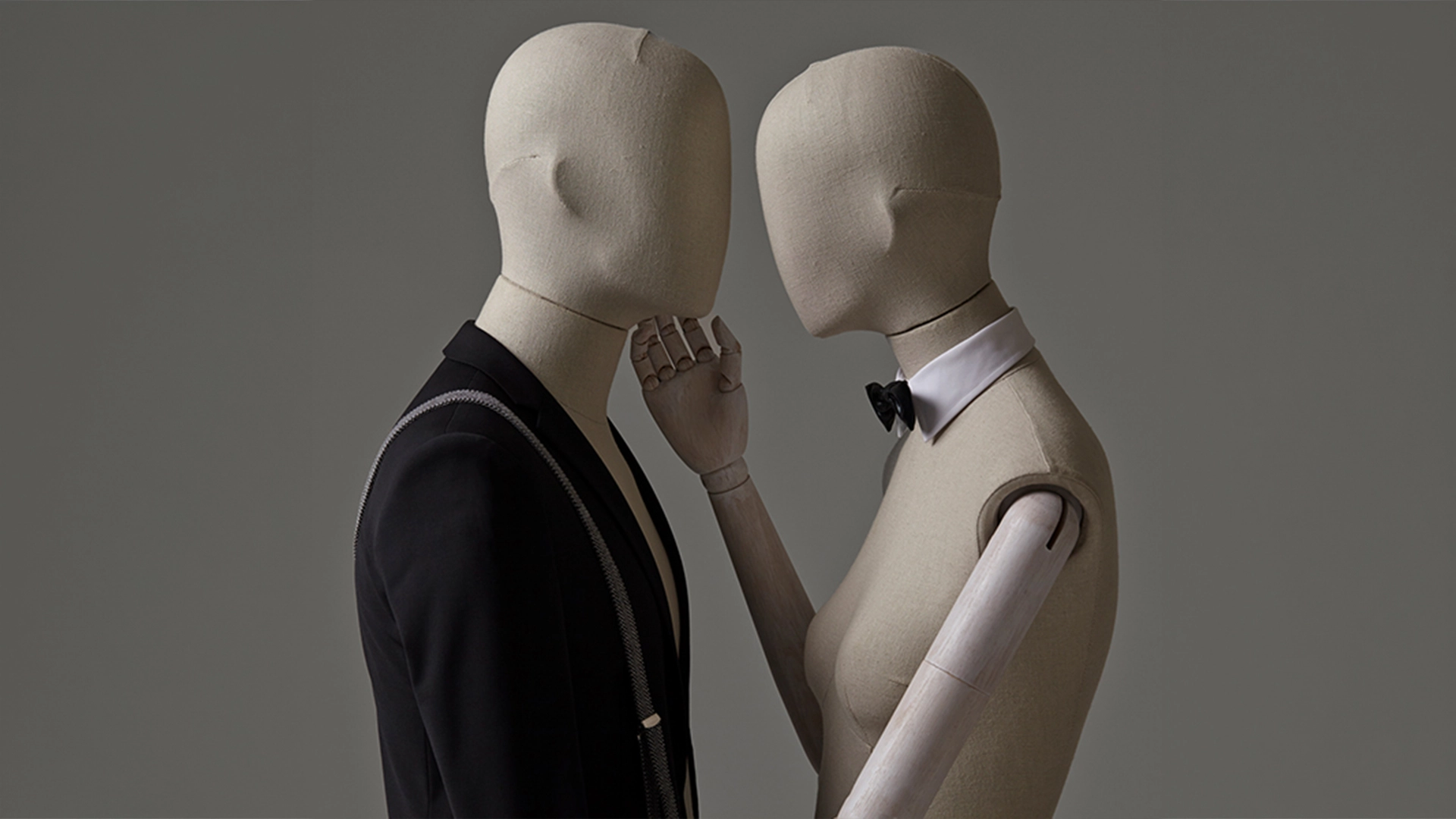 a pair of female and male mannequins from the casual fabric collection holding each other