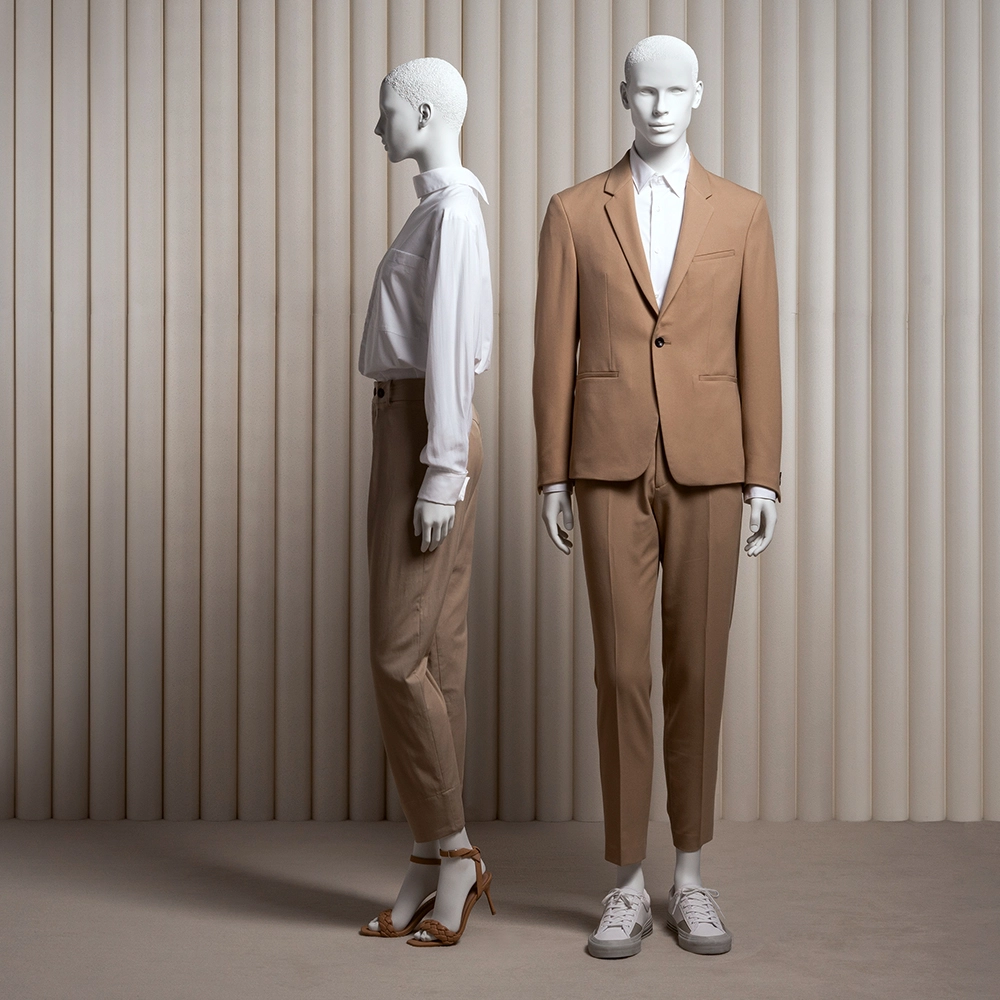 a pair of female and male mannequins with realistic heads and brown clothes on from the essential collection