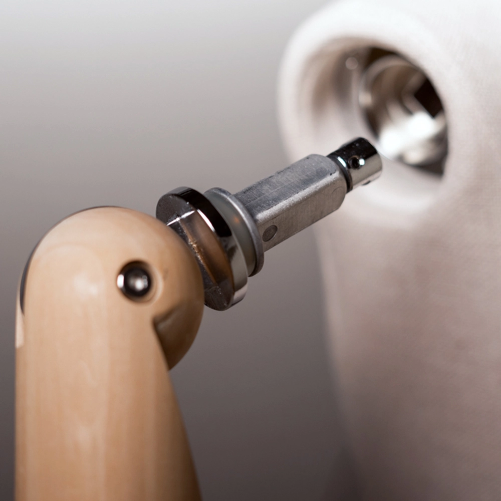 a closeup of the articulated arm pin being connected to the fabric female mannequin from the essential collection