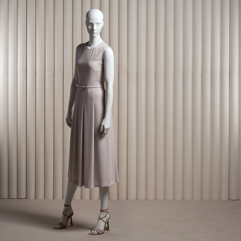 a female mannequin with realistic face wearing a pink long dress from the essential collection