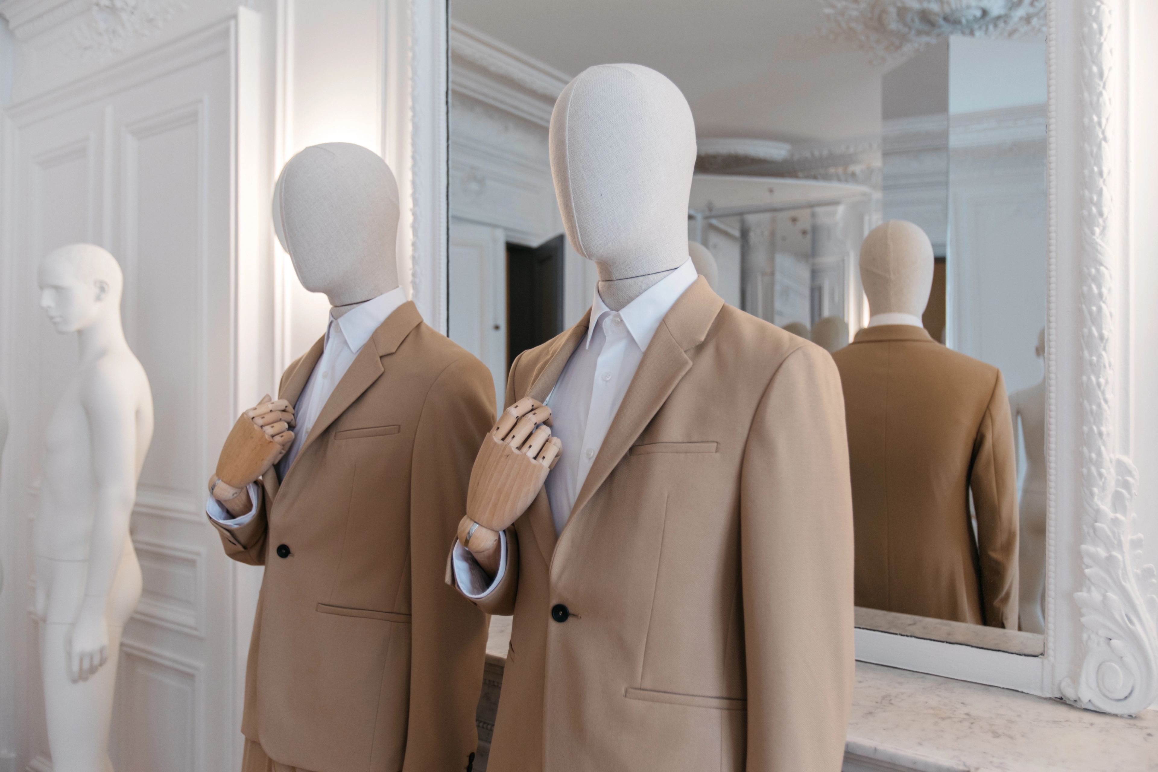 Two male mannequins in suits from the Essential Collection
