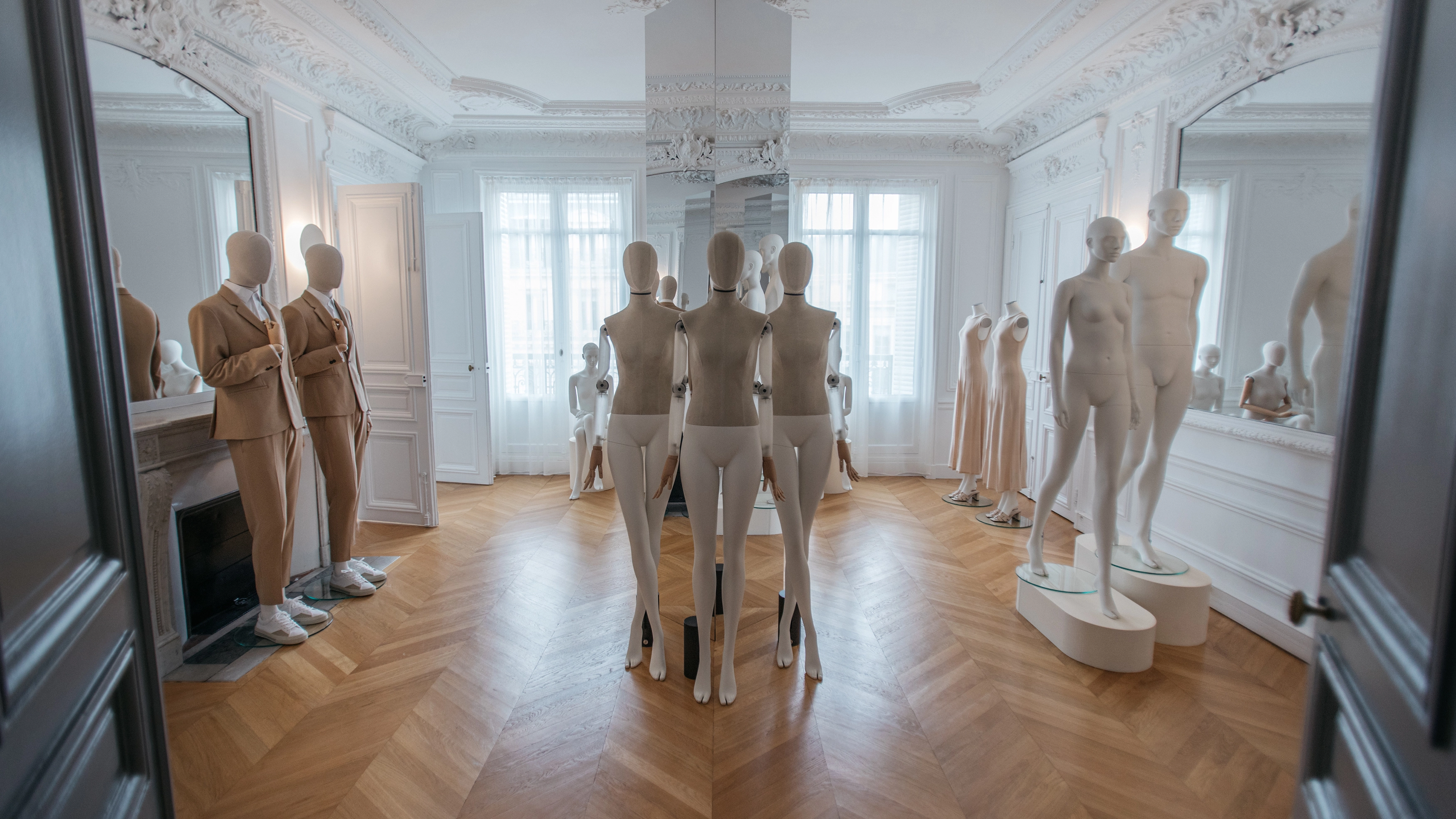 a Paris showroom showcasing different male and female mannequins from the essential collection
