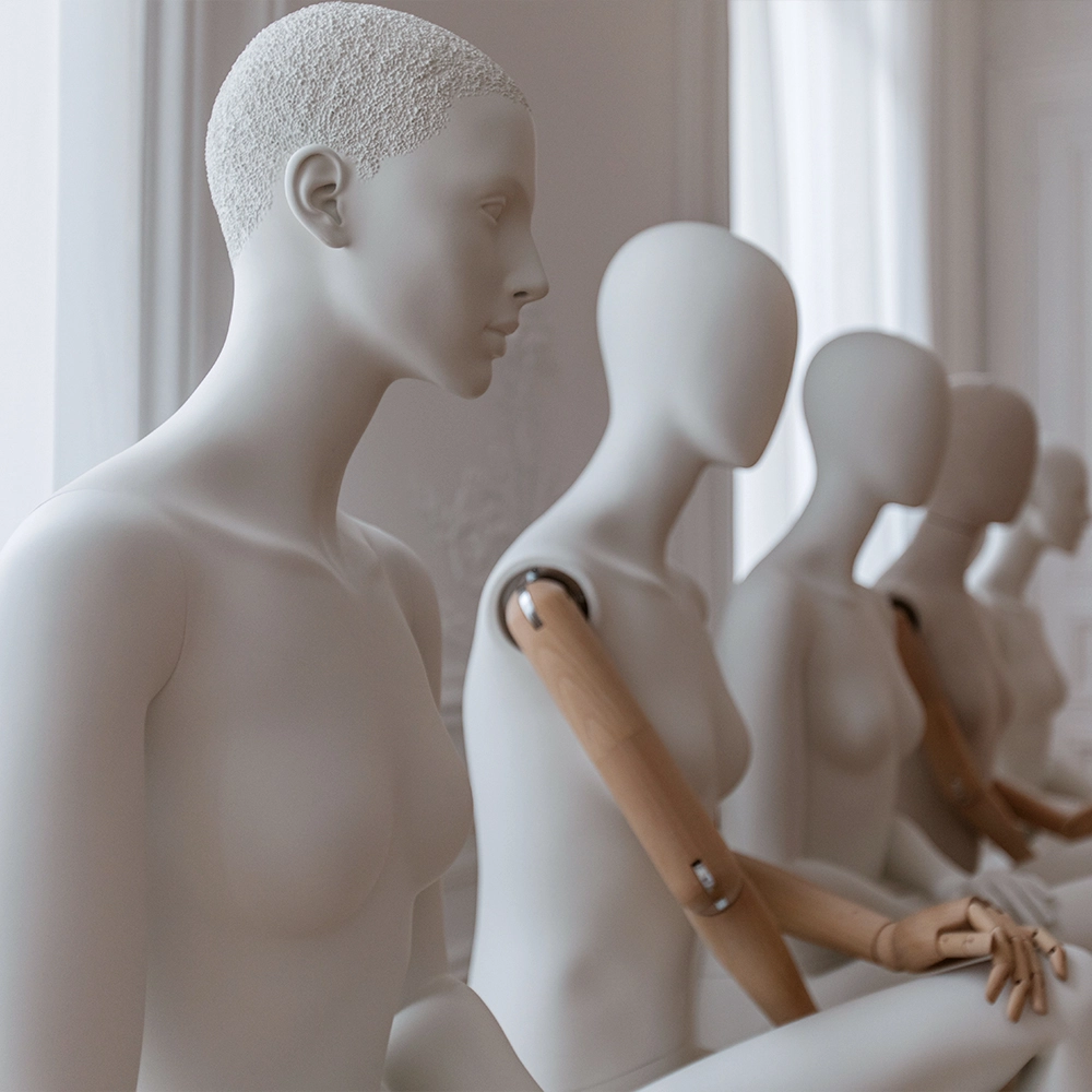 a group of female mannequins from the essential collection sitting down