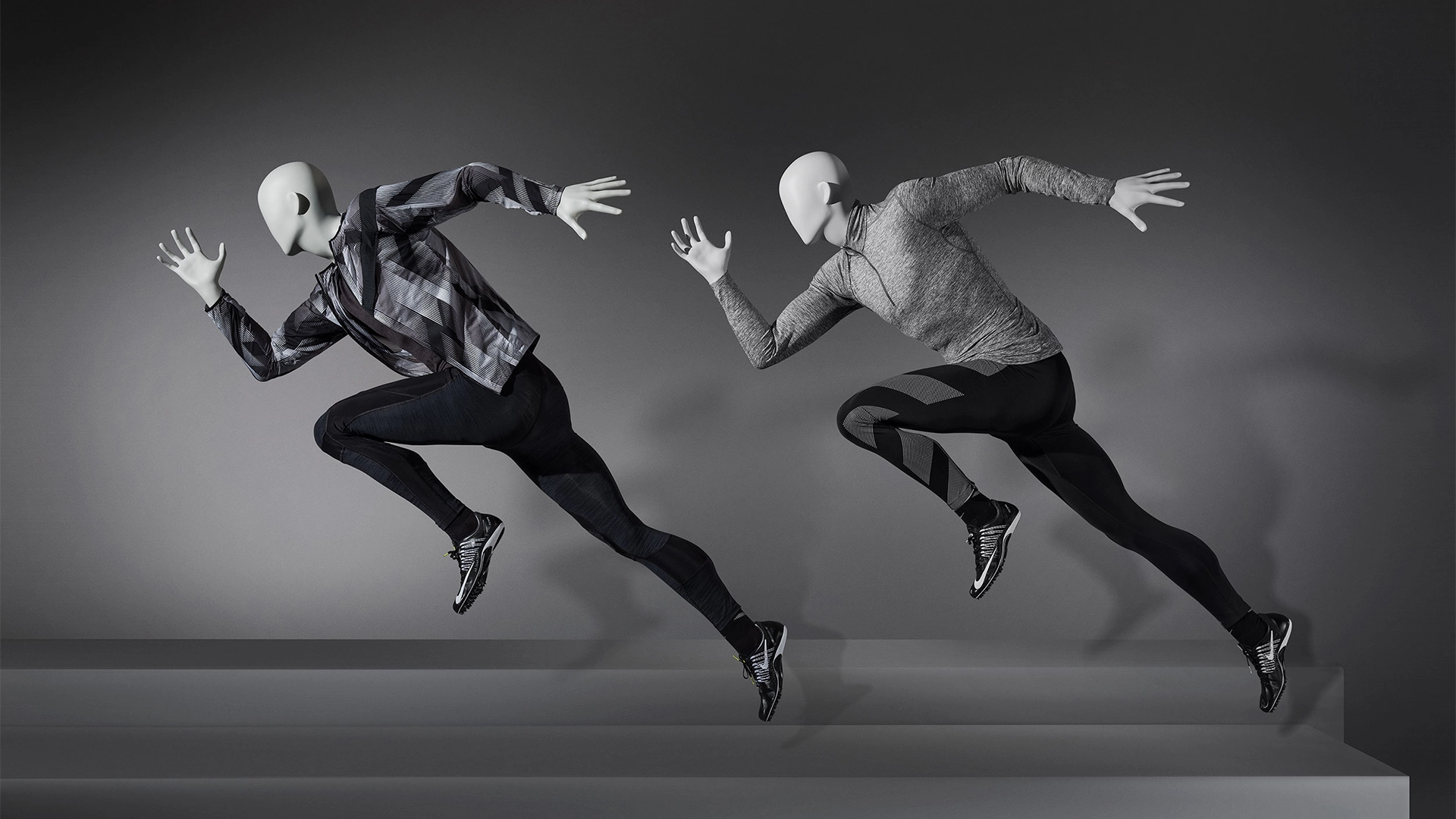 a pair of male sport mannequins in sprinting poses